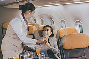 Air hostess flight cabin crew serve food and drink service passenger during travel on board