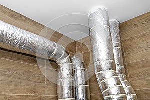 Air intake and exhaust in the home mechanical ventilation with heat recovery with visible insulated pipes with silver foil enterin