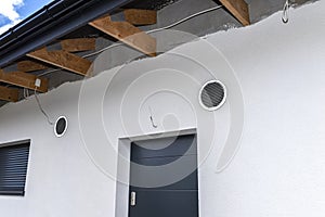 Air intake and exhaust in the wall of a single family house for mechanical ventilation with heat recovery, secured with a metal gr