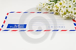 Air mail envelope with white cutter flower
