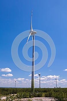 Air mills power station against the blue sky. Alternative energy.