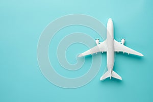 An air plane on blue background. Top view, white toy plane with copy space, minimal style. airliner, airplane, twin-engine jet