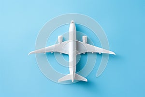 An air plane on blue background. Top view, white toy plane with copy space, minimal style. airliner, airplane, twin-engine jet