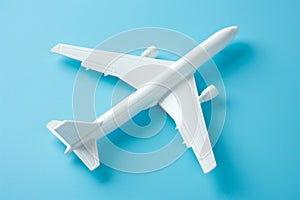 An air plane on blue background. Top view, white toy plane with copy space, minimal style. airliner, airplane, twin-engine jet