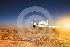 Air plane flying over cloud scape and sun light behind