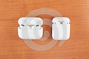 Air Pods Pro. with Wireless Charging Case. New Airpods pro on wooden background. Air pods. Copy space photo