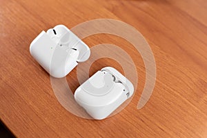 Air Pods Pro. with Wireless Charging Case. New Airpods pro on wooden background. Air pods. Copy space photo