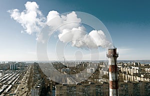 Air pollution, factory pipes, smoke from chimneys on sky background. Concept of industry, ecology, steam plant, heating season,