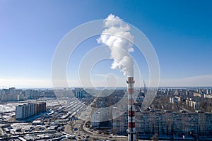 Air pollution, factory pipes, smoke from chimneys on sky background. Concept of industry, ecology, steam plant, heating season,