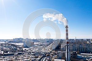 Air pollution, factory pipes, smoke from chimneys on sky background. Concept of industry, ecology, steam plant, heating season,