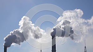Air pollution from industrial chimneys spew clouds smoke in sky