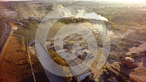 Air pollution by smoke coming out factory chimneys. Aerial