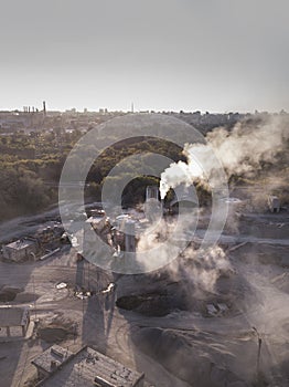Air pollution by smoke coming out factory chimneys. Aerial