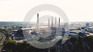 Air pollution by smoke coming out of five factory chimneys, industrial zone in the city, ecology concept. Stock footage