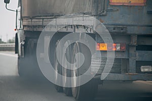 Air pollution from truck vehicle exhaust pipe on road