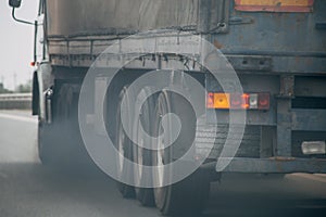 Air pollution from truck vehicle exhaust pipe on road photo