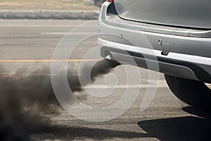 Air pollution from vehicle exhaust pipe on road