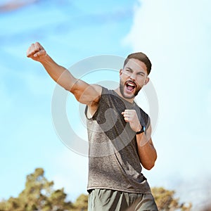 Air, punch and man with fist in air for achievement in fitness outdoor for exercise in park. Summer, workout and energy