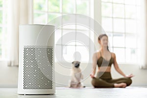 Air purifier in cozy white Living room for filter and cleaning removing dust PM2.5 HEPA at home