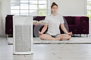 Air purifier in cozy white Living room for filter and cleaning removing dust PM2.5 HEPA at home