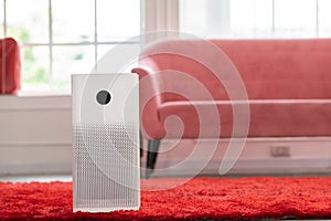 Air purifier in cozy white living room for filter and cleaning removing dust PM2.5 HEPA and virus in home,for fresh air and