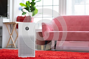 Air purifier in cozy white living room for filter and cleaning removing dust PM2.5 HEPA and virus in home,for fresh air and