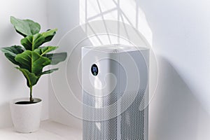 Air purifier a living room,  air cleaner removing fine dust in house. protect PM 2.5 dust and air pollution concept