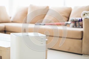 air purifier a living room  air cleaner removing fine dust in house. protect PM 2.5 dust and air pollution concept
