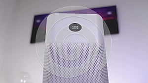 Air purifier with a small display indicating high level of impurity in the air