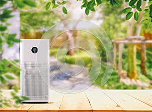 Air Purifier on the wood table at graden.  Air purification from viruses and bacteria