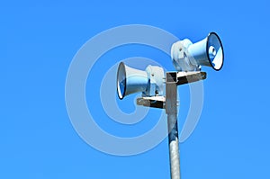 Air raid siren against blue sky