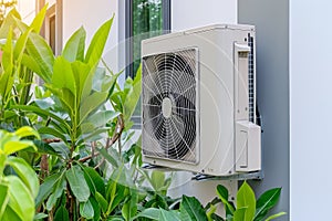 Air source heat pump installed in residential building, showcasing energy efficiency and eco friendly heating and cooling
