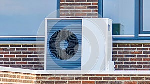 air source heat pump unit installed outdoors at a modern home with bricks in the Netherlands