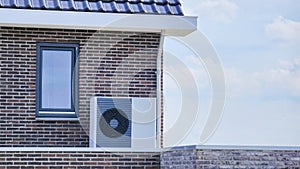 air source heat pump unit installed outdoors at a modern home with bricks in the Netherlands