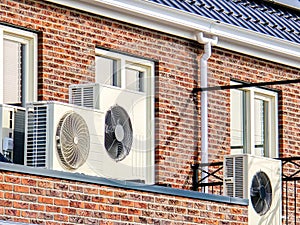 air source heat pump unit installed outdoors at a modern home with solar panels in the Netherlands