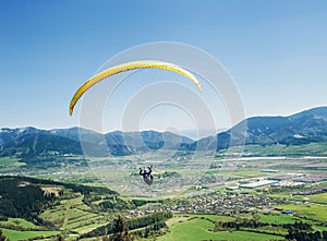 Air sportsman fly on paraplane over the mountain valley