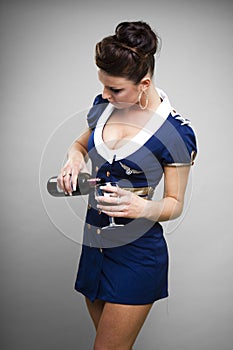 Air stewardess pouring drink