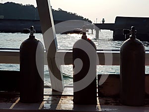 Air tanks in the slots for SCUBA divers on the boat, silhouette