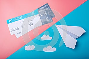 Air tickets and paper plane on pastel background, topview. Conce photo