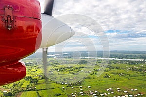 Air travel in Fiji, Melanesia, Oceania. View of Rewa river, Nausori town, Viti Levu island from a window of a small airplane.