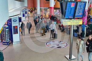 Air travellers check the flight departure information on large video screens in a lounge at Manchester`s Ringway Airport