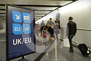 Air Travellers Proceed along EU / UK Arrivals Lane at an Airport