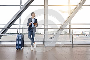 Air Travels. Young Middle Eastern Man Standing Near Window In Airport Terminal