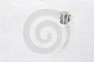 Air vent in white wall