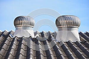 Air ventilator on the roof of home with blue sky