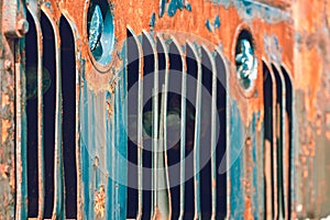 Air vents on the side of an old rusty rail locomotive.