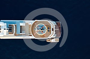 Air view of the helicopter on the deck of the yacht. Composition with sea transport. The sea and a yacht.