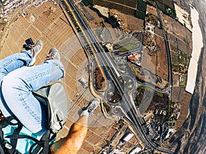 Air view of people couple doing paraglyde adrenaline experience - pilot and passenger paraglyiding over the city - outdoor