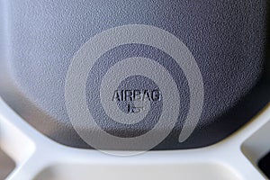 Airbag icon on steering wheel of car close up