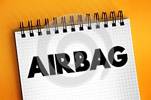Airbag is a vehicle occupant-restraint system using a bag designed to inflate extremely quickly, text concept on notepad
